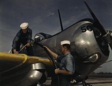 Feeding an SNC advanced training plane its essential supply of gas...Corpus Christi, Texas, 1942. Creator: Howard Hollem