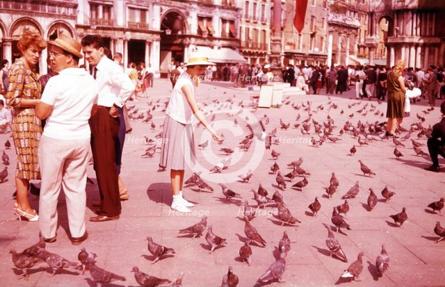 Feeding pigeons, St Mark's Square, Venice, Italy, c1955.  Creator: Arthur Charles Kirby Ware.