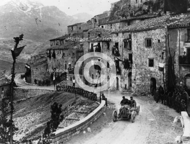 Felice Nazzaro driving through Pettralia Sottana in a Fiat, in the Targa Florio race, Sicily, 1907. Artist: Unknown