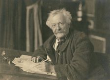 Félix Nadar seated at writing table, 1905-1910. Creator: Nadar
