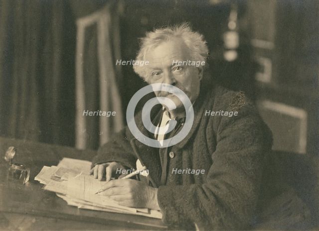 Félix Nadar seated at writing table, 1905-1910. Creator: Nadar.