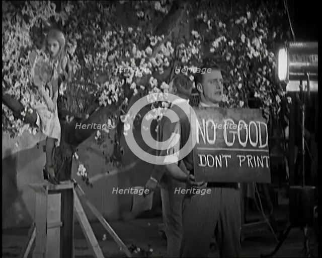 Female Actor Sitting in a Blossom Tree Whilst a Male Civilian Talks to Her..., 1920s. Creator: British Pathe Ltd.