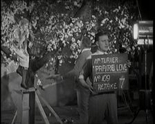 Female Actor Sitting in a Blossom Tree Whilst a Male Civilian Talks to Her..., 1920s. Creator: British Pathe Ltd