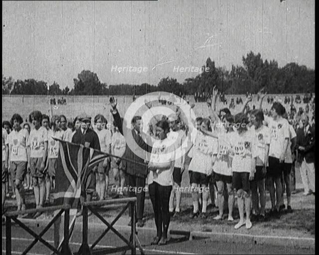 Female British Olympic Athletes Doing the Olympic Salute at the Women's World Games, 1922. Creator: British Pathe Ltd.