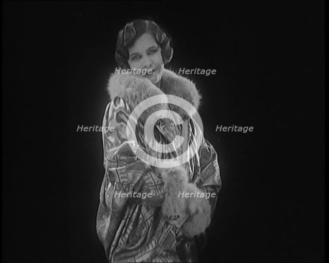 Female Civilian Modelling a Glamorous Fur Trimmed Coat, 1920. Creator: British Pathe Ltd.