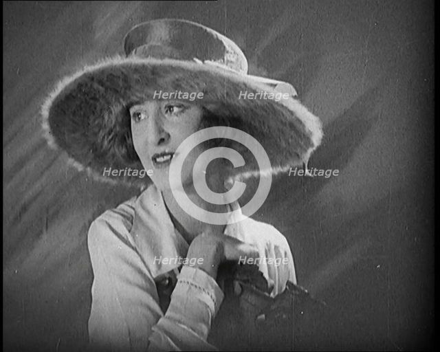 Female Civilian Modelling a Hat Decorated with a Ribbon and Fur, 1920. Creator: British Pathe Ltd.