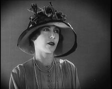Female Civilian Modelling a Hat Decorated with Flowers, 1920. Creator: British Pathe Ltd