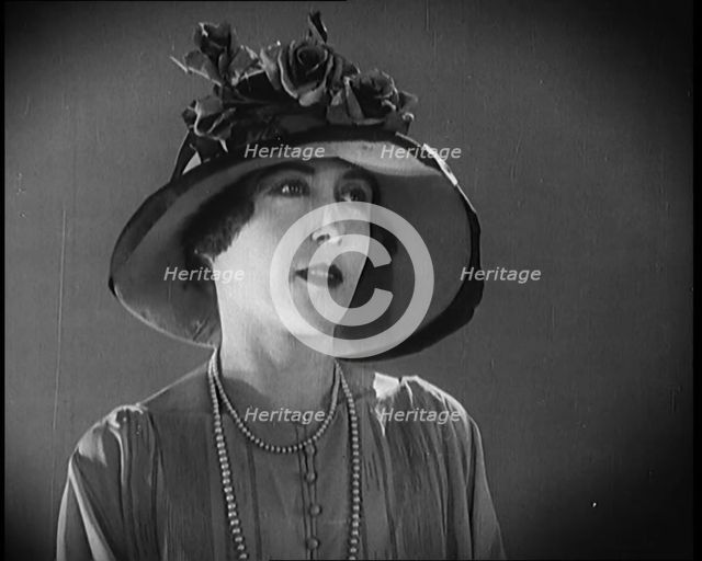 Female Civilian Modelling a Hat Decorated with Flowers, 1920. Creator: British Pathe Ltd.