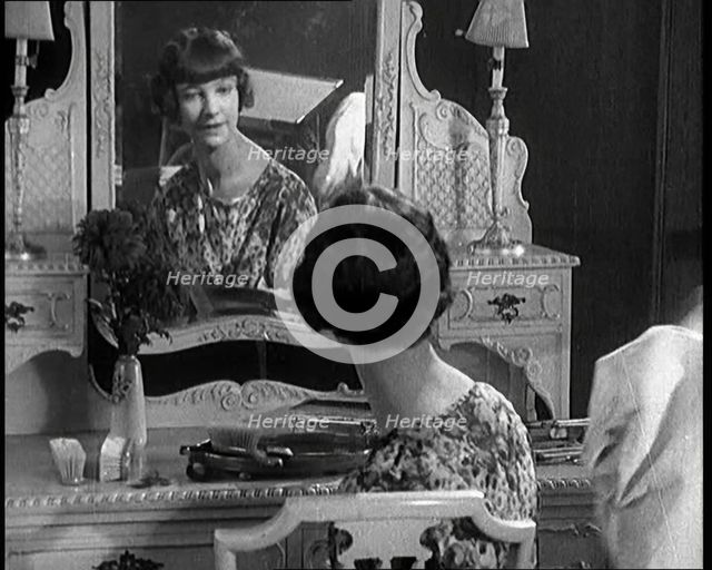 Female Civilian Admiring Herself in a Mirror After Having Her Hair Cut Into a 'Shingle', 1920. Creator: British Pathe Ltd.