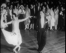 Female Civilian and Male Civilian Dancing in Front of a Crowd of People, 1926. Creator: British Pathe Ltd
