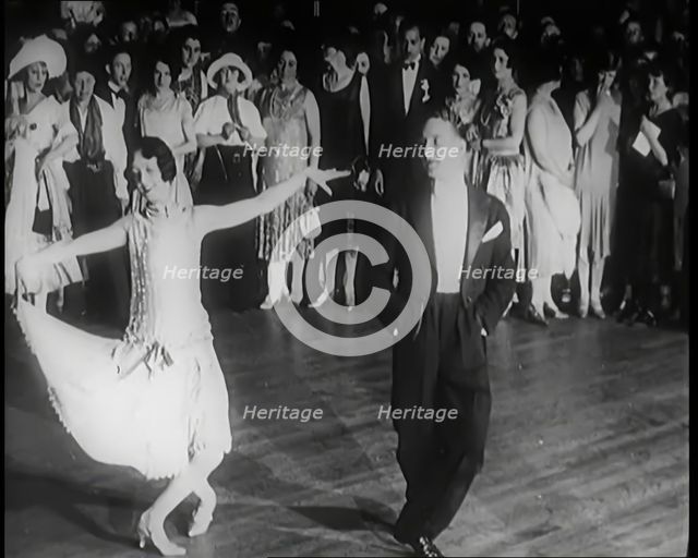 Female Civilian and Male Civilian Dancing in Front of a Crowd of People, 1926. Creator: British Pathe Ltd.