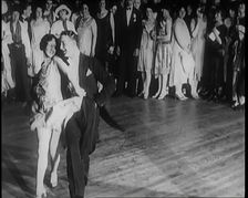 Female Civilian and Male Civilian Dancing in Front of a Crowd of People, 1926. Creator: British Pathe Ltd