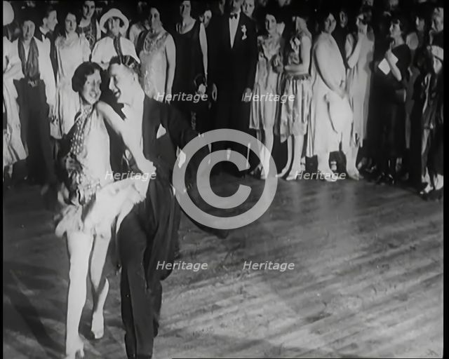 Female Civilian and Male Civilian Dancing in Front of a Crowd of People, 1926. Creator: British Pathe Ltd.