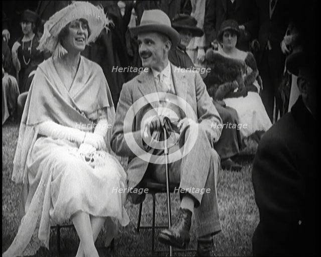 Female Civilian and Male Civilian Sitting on Chairs, 1924. Creator: British Pathe Ltd.