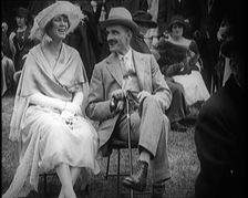 Female Civilian and Male Civilian Sitting on Chairs, 1924. Creator: British Pathe Ltd