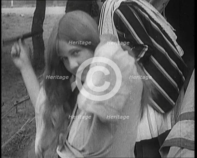 Female Civilian Brushing Her Long Hair Outdoors, 1920. Creator: British Pathe Ltd.