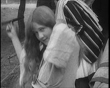 Female Civilian Brushing Her Long Hair Outdoors, 1920. Creator: British Pathe Ltd