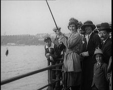 Female Civilian Fishing from a Pier Watched by a Small Crowd, 1920. Creator: British Pathe Ltd