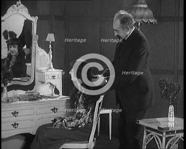 Female Civilian Having Her Hair Cut Into a 'Shingle' by a Male Civilian Hairdresser, 1920. Creator: British Pathe Ltd.
