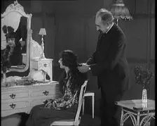 Female Civilian Having Her Hair Cut Into a Shingle by a Male Civilian Hairdresser, 1920. Creator: British Pathe Ltd