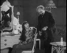 Female Civilian Having Her Hair Cut Into a Shingle by a Male Civilian Hairdresser, 1920. Creator: British Pathe Ltd