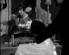 Female Civilian Having Her Hair Cut Into a Shingle by a Male Civilian Hairdresser, 1920. Creator: British Pathe Ltd