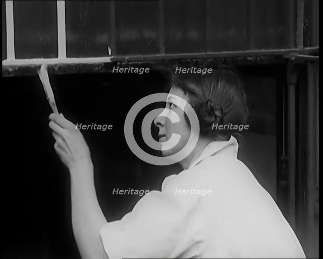 Female Civilian Painting a Building, 1931. Creator: British Pathe Ltd.