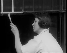 Female Civilian Painting a Building, 1931. Creator: British Pathe Ltd