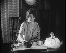 Female Civilian Seating at a Table Serving Tea, 1920. Creator: British Pathe Ltd