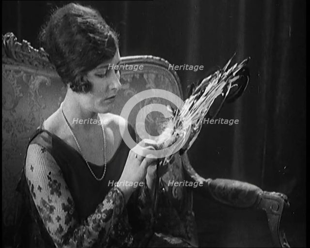 Female Civilian Seating Handling a Fan Made of Feathers, 1920. Creator: British Pathe Ltd.