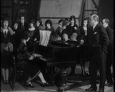 Female Civilian Singing Scales Badly Whilst Other Female Civilian is Playing the Piano in..., 1920s. Creator: British Pathe Ltd