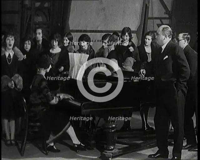Female Civilian Singing Scales Badly Whilst Other Female Civilian is Playing the Piano in..., 1920s. Creator: British Pathe Ltd.