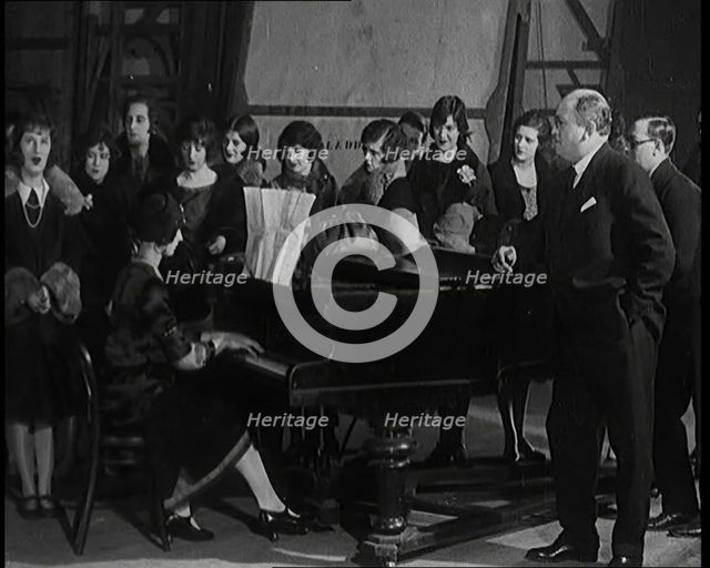 Female Civilian Singing Scales Badly Whilst Other Female Civilian is Playing the Piano in..., 1920s. Creator: British Pathe Ltd.