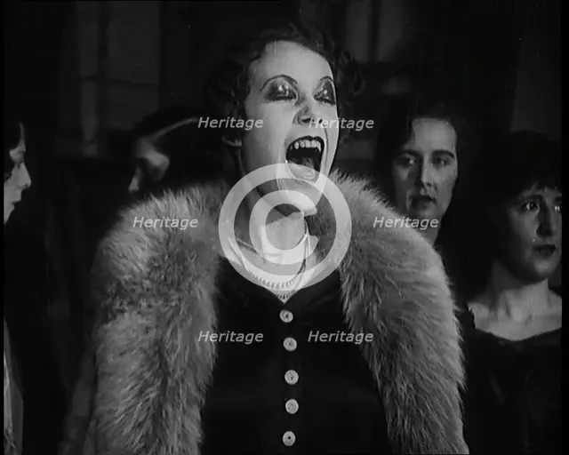 Female Civilian Singing Scales Badly Whilst Other Female Civilian is Playing the Piano in..., 1920s. Creator: British Pathe Ltd.
