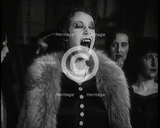 Female Civilian Singing Scales Badly Whilst Other Female Civilian is Playing the Piano in..., 1920s. Creator: British Pathe Ltd.