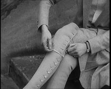 Female Civilian Using a Button Hook to Button up Her Leather Boots, 1920. Creator: British Pathe Ltd