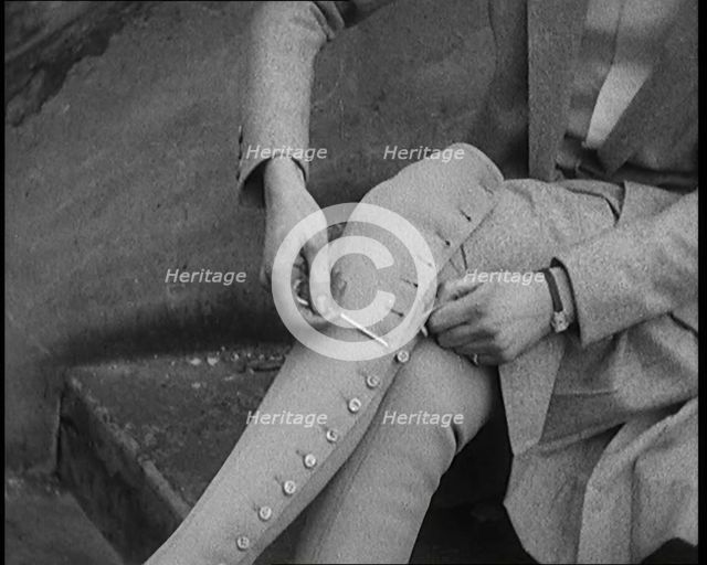 Female Civilian Using a Button Hook to Button up Her Leather Boots, 1920. Creator: British Pathe Ltd.