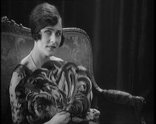 Female Civilian Using a Fan Made of Feathers, 1920. Creator: British Pathe Ltd