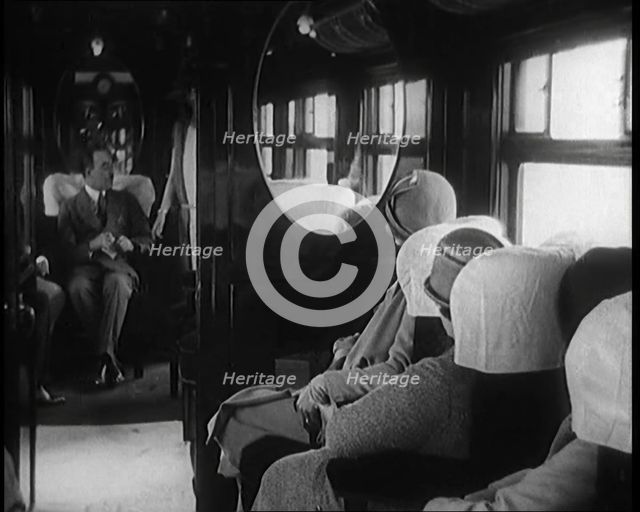 Female Civilian Wearing a Dress and Hat Modelling in Front of a Small Audience Inside a..., 1920. Creator: British Pathe Ltd.