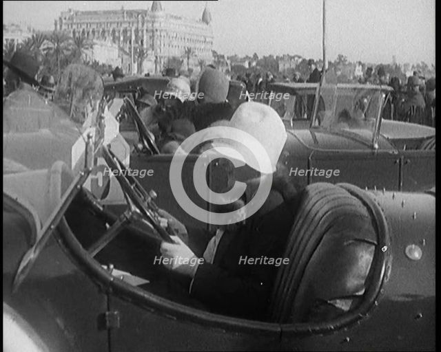 Female Civilian Wearing a Fur Trimmed Coat and Hat Sitting Behind the Wheel of a Car, 1920. Creator: British Pathe Ltd.