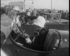 Female Civilian Wearing a Fur Trimmed Coat and Hat Sitting Behind the Wheel of a Car, 1920. Creator: British Pathe Ltd