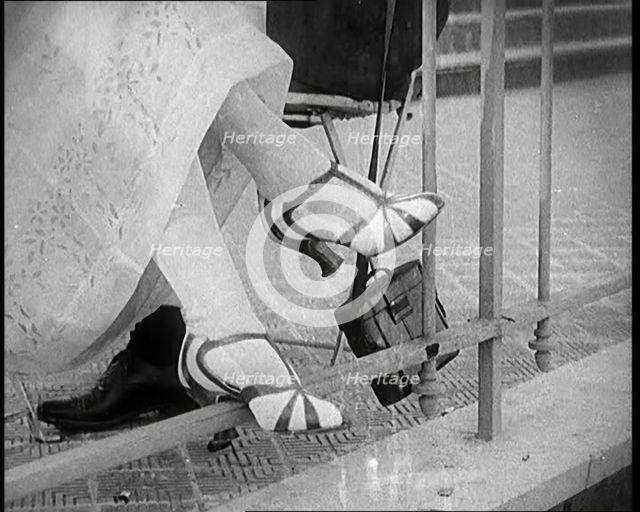 Female Civilian Wearing a Smart Heeled Pair of Shoes in Stripes, 1920. Creator: British Pathe Ltd.