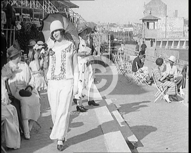 Female Civilian Wearing Smart outfit and Hat Holding a Parasol Walking Towards the Camera..., 1920. Creator: British Pathe Ltd.