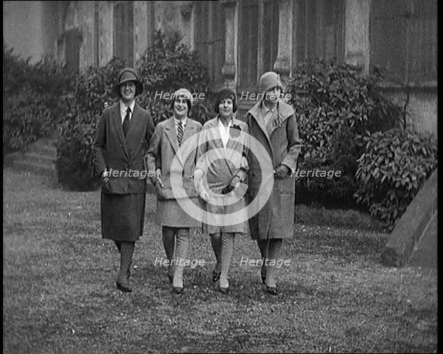Female Civilians Wearing Glamorous Outfits and Wool Stockings Walking down a Street, 1920. Creator: British Pathe Ltd.