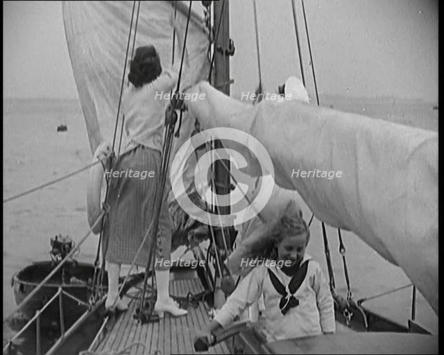 Female Civilians Wearing Summer Outfits and a Captain's Hat Onboard of a Boat Hoisting up a..., 1920 Creator: British Pathe Ltd.