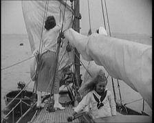 Female Civilians Wearing Summer Outfits and a Captain's Hat Onboard of a Boat Hoisting up a..., 1920 Creator: British Pathe Ltd