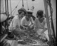 Female Civilians Wearing Summer Outfits and a Captain's Hat Onboard of a Boat Untangling a Rope,1920 Creator: British Pathe Ltd