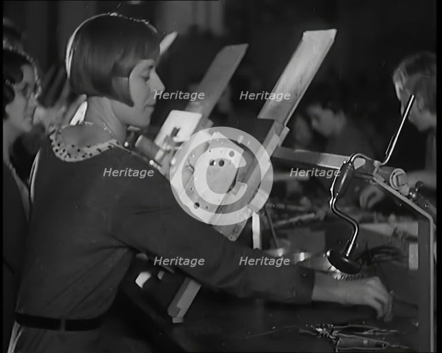 Female Civilians Working on a Factory Production Line, 1931. Creator: British Pathe Ltd.