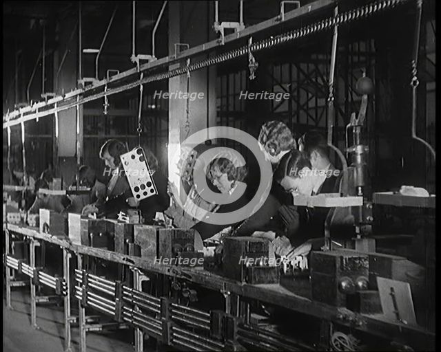 Female Civilians Working on a Factory Production Line, 1931. Creator: British Pathe Ltd.