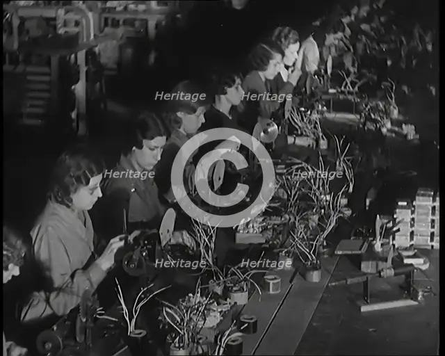 Female Civilians Working on a Factory Production Line, 1931. Creator: British Pathe Ltd.